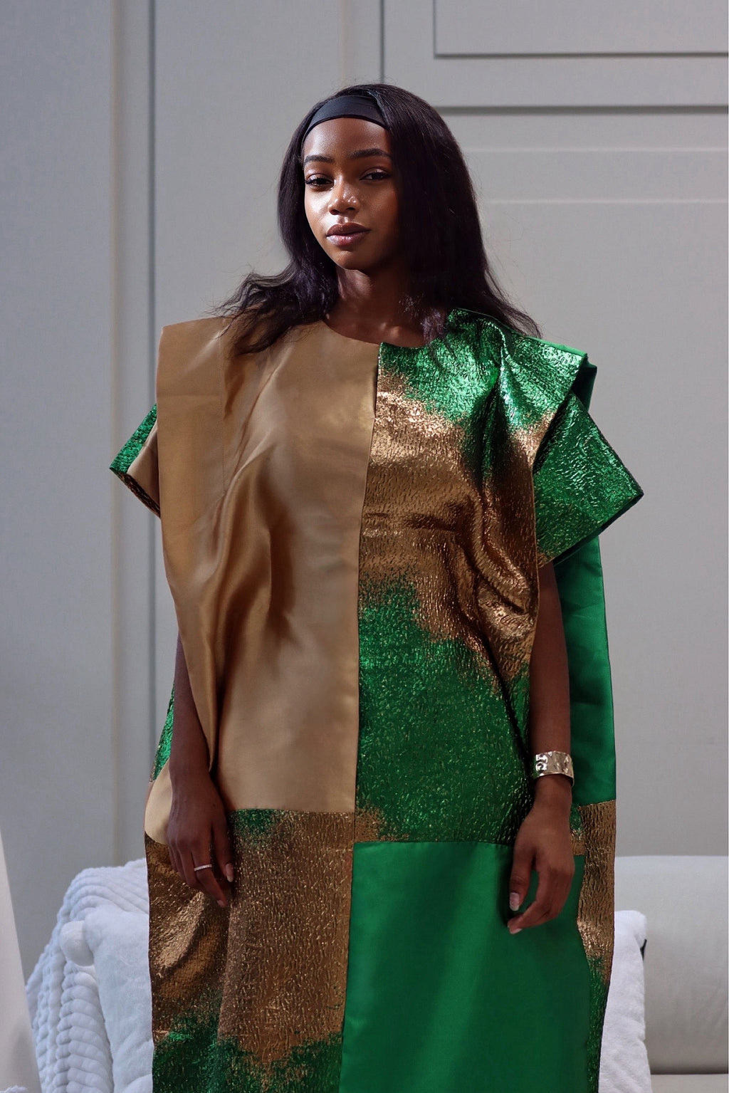 golden mikado dress A classic golden-yellow dress in rich mikado fabric falls gracefully into an elegant back train, with gathered tulle detailing at the hem. A subtle, delicate bow enhances the design, adding a refined